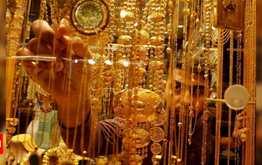 Gold prices in check as central banks rev up policy tightening - Times of India