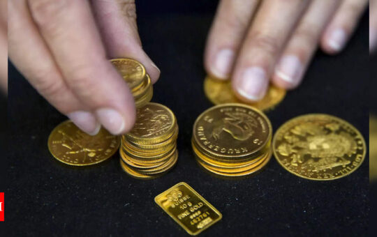 Gold drops to near one-year low as rate-hike fears loom - Times of India